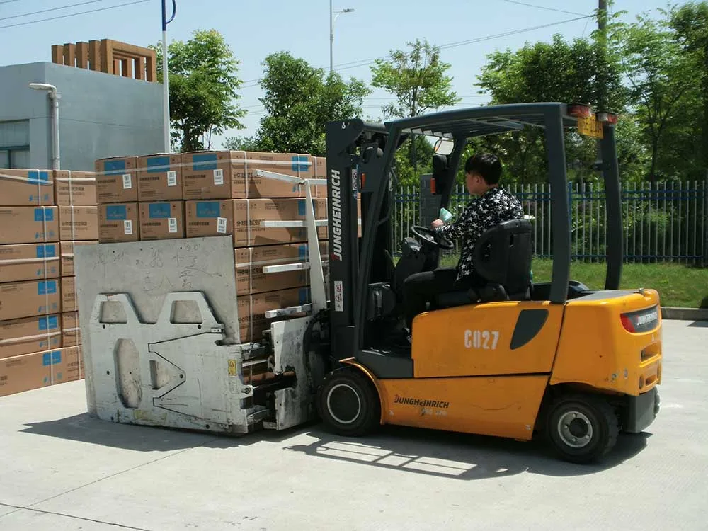 Attachment xe nâng kẹp thùng carton lắp trên xe nâng điện đang nhấc khối thùng